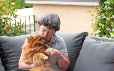 elderly woman holding small dog